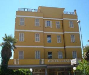 a large yellow building with a hotel at Hotel Le Najadi in Santa Marinella