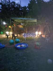 a backyard at night with a tent and a baby in a basket at Villa Konstantinos in Olympiaki Akti