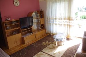 a living room with a tv and a entertainment center at ASTREA in Rijeka