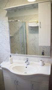 a bathroom with a sink and a mirror at ASTREA in Rijeka +13 photos