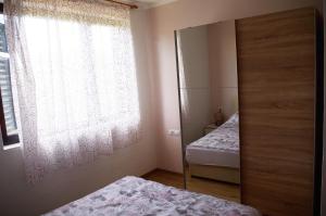 a bedroom with two beds and a window at ASTREA in Rijeka