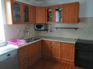 a kitchen with wooden cabinets and a sink at ASTREA in Rijeka