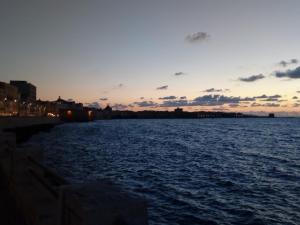 a view of a body of water at sunset at Appartamento Scarlatti in Trapani +26 photos