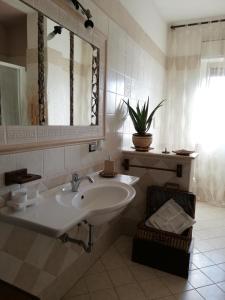 a white bathroom with a sink and a mirror at Villa Santa Elena B&B - Country Home Holiday in Sala Consilina