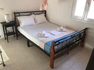 a bedroom with a bed with two towels on it at Anna House Palouri in Paliouri