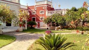 un grand bâtiment rouge avec une cour en face dans l'établissement Villa Ida in Bari, à Bari