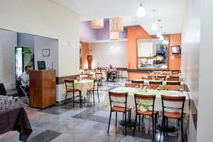 a restaurant with tables and chairs and people sitting at tables at Hotel San Francisco Centro Histórico in Mexico City +31 photos