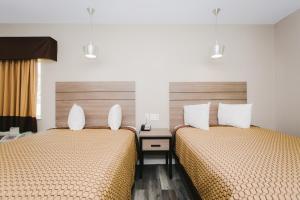 Postel nebo postele na pokoji v ubytování Palace Inn- Louetta