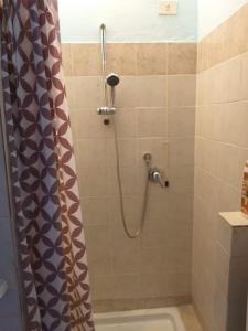 a bathroom with a shower with a shower curtain at Appartamento Giusy in Foligno