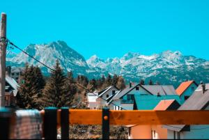 a view of a town with mountains in the background at Apartmani Srećko in Žabljak