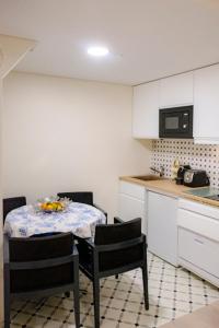 a small kitchen with a table and chairs in a room at Apartment Trindade Way in Porto