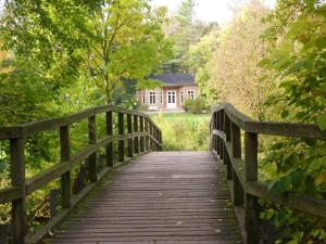 a wooden bridge with a house in the background at Haus Constantin in Weimar