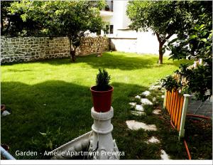 a potted plant sitting in a yard at Amelie Apartment in Preveza