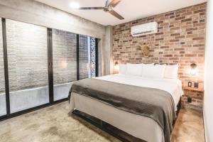 A bed or beds in a room at Lofts On Basilio
