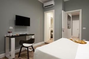 Ένα ή περισσότερα κρεβάτια σε δωμάτιο στο Dante Maison de Prestige