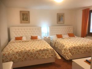 a bedroom with two beds and a table with a lamp at Apartment pod Lysou in Frýdlant nad Ostravicí