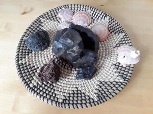 a plate of rocks and minerals on a table at Guesthouse Vestri-Gardsauki in Hvolsvöllur