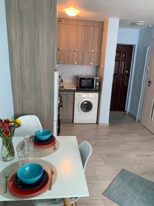 a kitchen with a white table with plates on it at Apartament Centrum Pańska in Warsaw