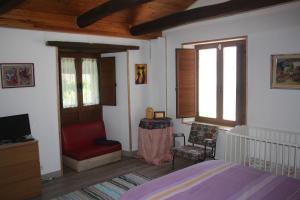 a bedroom with a bed and a tv and a window at El Rinconcito de Llamas in Llamas de la Ribera