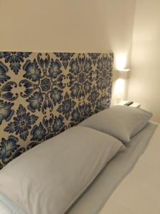 a bedroom with a bed with a blue and white wall at la casetta in Favignana