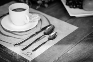 a group of tongs and a cup of coffee on a table at Pousada Tankamana in Itaipava