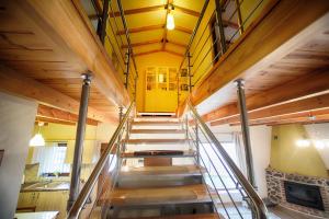 a staircase in a house with yellow walls and wooden ceilings at La Noi in Sidhirokhórion