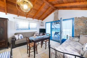 a living room with a table and a couch at Agyrovoli Bungalow in Skala Kallirachis