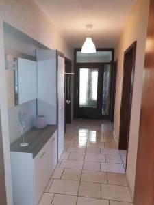 a hallway with a room with a door and a tile floor at Ferienwohnung Toge in Wadgassen