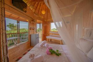 a bedroom with a bed in a wooden house at Zante Lagos holiday homes Treehouse and Villa in Vouyiáton