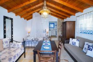 a living room with a table and a couch at Agyrovoli Bungalow in Skala Kallirachis