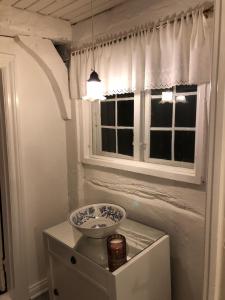 a bathroom with a sink and a window at Madam Bundsens Huse in Assens +22 photos