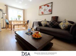 a living room with a couch and a table with fruit on it at Birmingham Stunning Beauty 3 beds3 baths Homebase for NECAirport in Birmingham