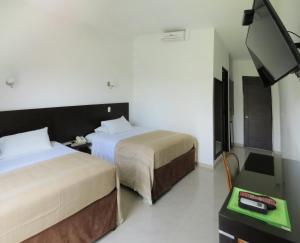 Кровать или кровати в номере Hotel Estrella Palmira