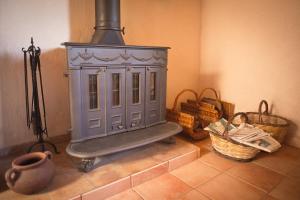 a stove sitting on top of a floor with baskets at Casa Rural Los Patos in Hermigua