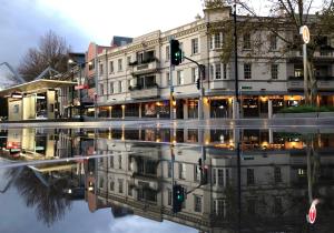 a city street with a reflection of a building at The Lucky Hotel in Newcastle +41 photos