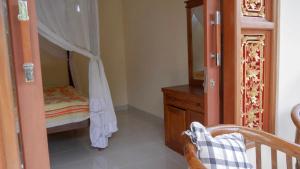 Postel nebo postele na pokoji v ubytování Arya Homestay