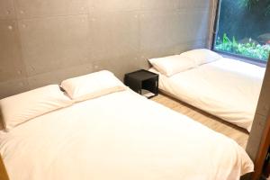 Voodi või voodid majutusasutuse 森旅行 toas