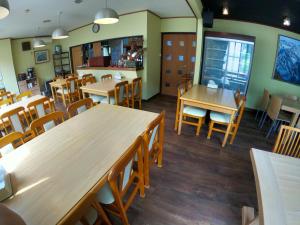 a dining room with wooden tables and chairs at Yuzawa Ski House in Yuzawa