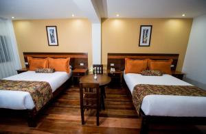 En eller flere senge i et værelse på Posada San Blas