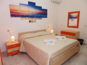 a bedroom with a bed with two towels on it at Casa Venere in Lampedusa