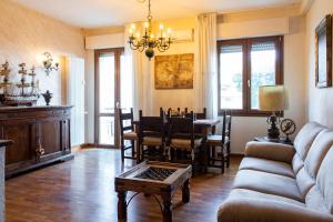 a living room with a table and a dining room at Appartamento "Città giardino" vista mare con parcheggio privato in Viareggio