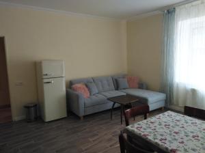 a living room with a couch and a table at Apartmán Nostalgie in Telč