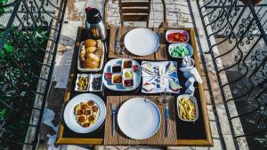 a wooden table with plates of food on it at Capiedra Hotel in Uçhisar
