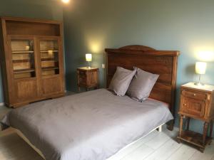 a bedroom with a large bed with two night stands at Le petit verger in Dompierre-les-Tilleuls