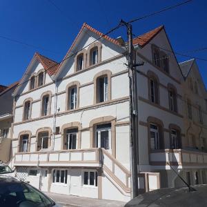 a large white building with a red roof at Studio "La Plage" - 50m Front de Mer in Berck-sur-Mer