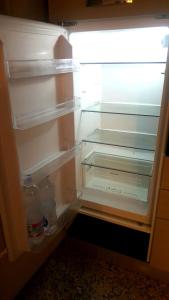 an empty refrigerator with its door open and empty shelves at Montevenere 83 in Chiusi