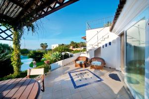 a patio with chairs and a table on a house at Villa Formica in Ischia