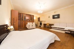 a large bedroom with a white bed and a couch at GoodRest on Ekaterininskaya in Odesa