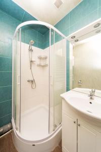 a bathroom with a shower and a sink at GoodRest on Ekaterininskaya in Odesa +10 photos