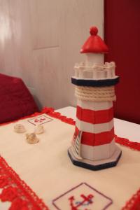a cake with a lighthouse on top of a table at La casa del pescatore in Oliveri